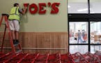 Jacob Meister, an installer with Electro Signs, put the Trader Joe’s sign up at the store on South Washington Avenue to prepare for the 2018 opening