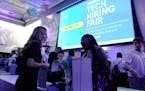 File - Visitors attend the Venture Miami Tech Hiring Fair at the Miami-Dade College, Wolfson campus, Wednesday, April 26, 2023, in Miami. On Friday, t