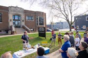Tom Goldstein, one of the founding members of “Renovating 1558,” spoke to a small crowd outside of Hamline-Midway Library in St. Paul in May.