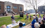 Tom Goldstein, one of the founding members of “Renovating 1558,” spoke to a small crowd outside of Hamline-Midway Library in St. Paul in May.