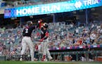 Minnesota Twins’ Michael A. Taylor (2), left, celebrates with Christian Vazquez after hitting a solo home run during the fifth inning of a baseball 