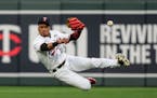 Twins second baseman Jorge Polanco missed the catch before grabbing it and throwing to first to get Cleveland’s Andres Gimenez out at first in the s