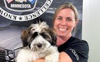 Police Detective Andrea Newton holds Doc, the Burnsville Police Department’s new wellness dog.