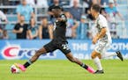 Minnesota United forward Bongokuhle Hlongwane kicks the ball away from Toronto FC midfielder Kobe Franklin in the first half 