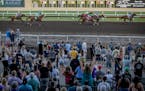 Race fans cheer on the horses during race seven on opening night at Canterbury Park in Shakopee, Minn., on Saturday, May 27, 2023. ] Elizabeth Flores 