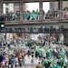 Paradegoers try to stay warm while watching St. Paul’s St. Patrick’s Day parade on March 17 in downtown St. Paul. We hope visitors patronize the d