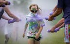 First grader Taylor Strauss participates in the 5th annual Color Dash at Victoria Elementary School in Victoria, Minn. on Monday, June 5, 2023. Studen
