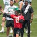 New York Jets quarterback Aaron Rodgers (8) throws during a drill on Tuesday.