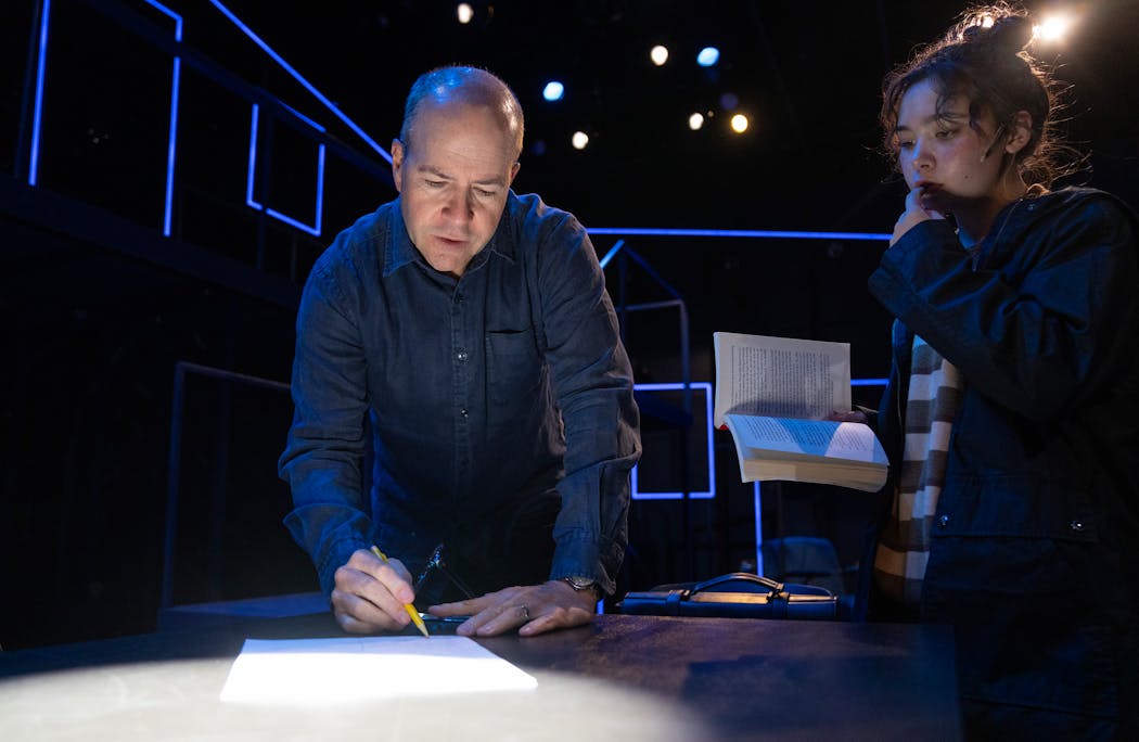 Peter Rothstein makes notes while working with Audrey Mojica, who portrays the daughter Natalie, during a rehearsal of “Next to Normal.” 