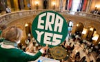 Kathryn Ringham holds up an ERA YES sign in the State Capitol Rotunda during a rally for the Equal Rights Amendment, Monday, Jan. 31, 2022, St. Paul, 