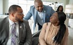 Damon Jenkins (center), the Twin Cities regional market president of First Independence Bank, spoke with Donte Stamps (left) and Charlotte Epee on Wed