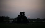 A couple watches the sun set over Crystal Lake on May 16, 2023. Wildfire smoke is expected to create poorer air quality conditions for the remainder o