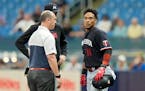 Minnesota Twins’ Jorge Polanco spoke to manager Rocco Baldelli and a trainer after getting hurt running to first base during the first inning.