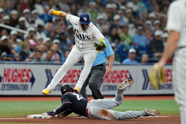 Michael A. Taylor of the Twins stole third in the ninth inning Wednesday as Rays third baseman Isaac Paredes avoided him.