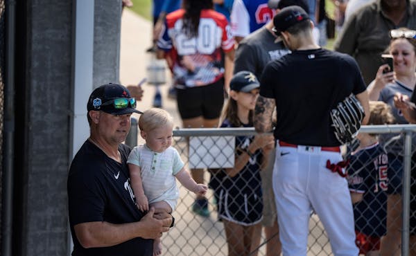 St. Paul Saints manager Toby Gardenhire with son Bodie, who attended training camp in February, when he was eight months old.