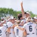 Paige Zender rose above the group hug by Rosemount’s players to indicate her team’s status in Class 4A softball.