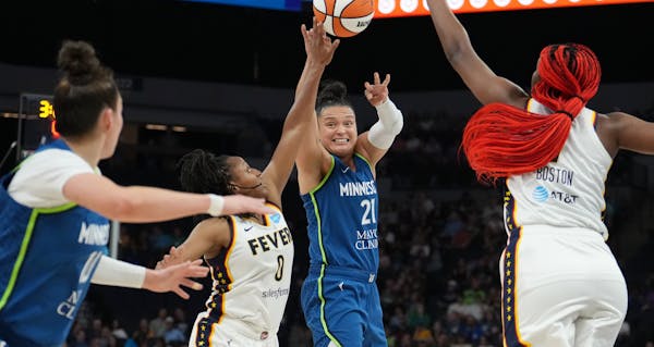 Lynx guard Kayla McBride passes the ball to forward Jessica Shepard under pressure from Indiana Fever guard Kelsey Mitchell in the second quarter Frid