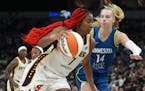 Minnesota Lynx forward Dorka Juhasz (14) races to defend as Indiana Fever forward Aliyah Boston (7) drives to the basket in the third quarter of a WNB