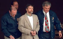 U.S. Marshals prepared to take Theodore Kaczynski down the steps at the federal courthouse to a waiting vehicle on June 21, 1996, in Helena, Mont. 