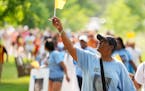 Mothers Against Community Gun Violence founder LaTanya Black raises an orange flag that has come to be a symbol of gun violence awareness during the N