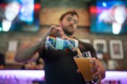 Nick Herrera, a bartender at the Saloon, poured a “Hello My Pronouns Are” beer by Modist Brewing Co. The Saloon bar announced it cut ties with Anh