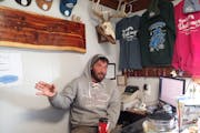 Kevin Hinrichs, aka “The Dutchman,’’ telling stories behind the front desk at his Rainy River fishing resort.