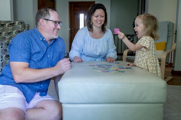 Miraya and Andy Gran played a game with daughter Isla, 2, at home in Bloomington. Isla was conceived through in-vitro fertilization.