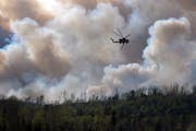 A service helicopter dumps water on a back burn along the Gunflint Trail in 2007.