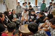St. Paul’s American Indian Magnet School’s Thomas Draskovic, left, works with the school’s drum group, “Many Nations of People.” As a teache