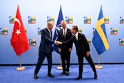 Turkish President Recep Tayyip Erdogan, left, shakes hands with Swedish Prime Minister Ulf Kristersson, right, as the Secretary General of NATO Jens S