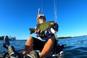 Joey Vanyo, president of Minnesota Kayak Bass Fishing League, with an 18-inch smallmouth bass caught on Lake Koronis.