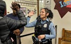 In this 2019 photo, Minneapolis police officer and school resource officer Drea Leal greeted a passing student as she did her rounds in the hallways o