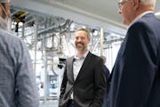 DEED Commissioner Matt Varilek, center, and Gov. Tim Walz toured a manufacturing site for the company Bühler as the governor kicked off a statewide w