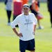 Denver Broncos head coach Sean Payton looks on as players take part in drills Thursday.