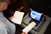 Brad Anderson ran a test vote using a stack of regular ballots mixed with the narrower ballots from the new Express Vote machines Tuesday.