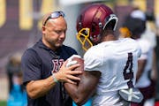 Gophers coach P.J. Fleck speaks with wide receiver Corey Crooms Jr. during Tuesday’s practice at Athlete Village.