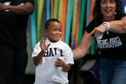 Preschool grad Nakyi Hammons waved to his family as his name was announced at his graduation ceremony.