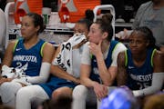 Minnesota Lynx forward Napheesa Collier (24), guard Kayla McBride (21), forward Jessica Shepard (10), and guard Tiffany Mitchell (25) sat on the bench