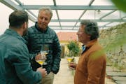 Author Dan Buettner, center, Afianes Wines founder Nikos Afianes, right, and his son Konstantinos Afianes drink to their health in Ikaria, Greece, in 
