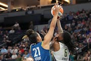 Lynx guard Kayla McBride (21) battled Wings forward Natasha Howard (6) for a rebound in the second half July 12 at Target Center. The two teams will m