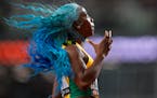 Shelly-Ann Fraser-Pryce, of Jamaica anchors her team to win a Women’s 4x100-meters relay heat during the World Athletics Championships in Budapest, 