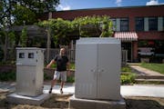 Mim’s Cafe owner Mahmoud Shahin stood next to electrical boxes in front of his cafe in St. Paul on Aug. 8.