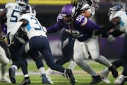 Minnesota Vikings defensive tackle Sheldon Day (52) gets an arm around Tennessee Titans running back Tyjae Spears (32) in the first quarter of an NFL 