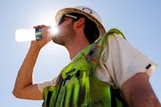 Construction inspector Zach Garner drinks cold water while working in Antioch, Calif., in 2022. California has an outdoor heat standard for workers, b
