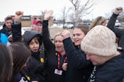 Union employees huddle and cheer outside the Cub in Maple Grove on Wednesday, April 5, 2023.