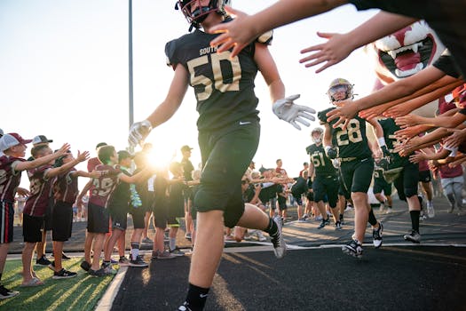 Lakeville South players ran out of the tunnel between lines of youth football players before their season opener against Wayzata on Friday, Sept. 1, 2