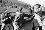 Students fought outside Boston’s Hyde Park High School in 1975. That unrest is featured in PBS’ “The Busing Battleground” Monday. 