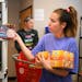 Food shelf coordinator Jayme Hamburger recently stocked dog food at the People & Pets Together food shelf in Minneapolis, which merged with the Minnet