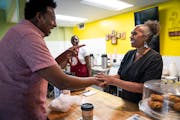 Owner Stephanie Wright talked with DFL state Rep. Samakab Hussein while she worked at Golden Thyme Coffee & Cafe in St. Paul. 