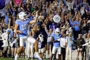 North Carolina quarterback Drake Maye celebrated a rushing touchdown in double overtime against Appalachian State on Saturday in Chapel Hill, N.C.